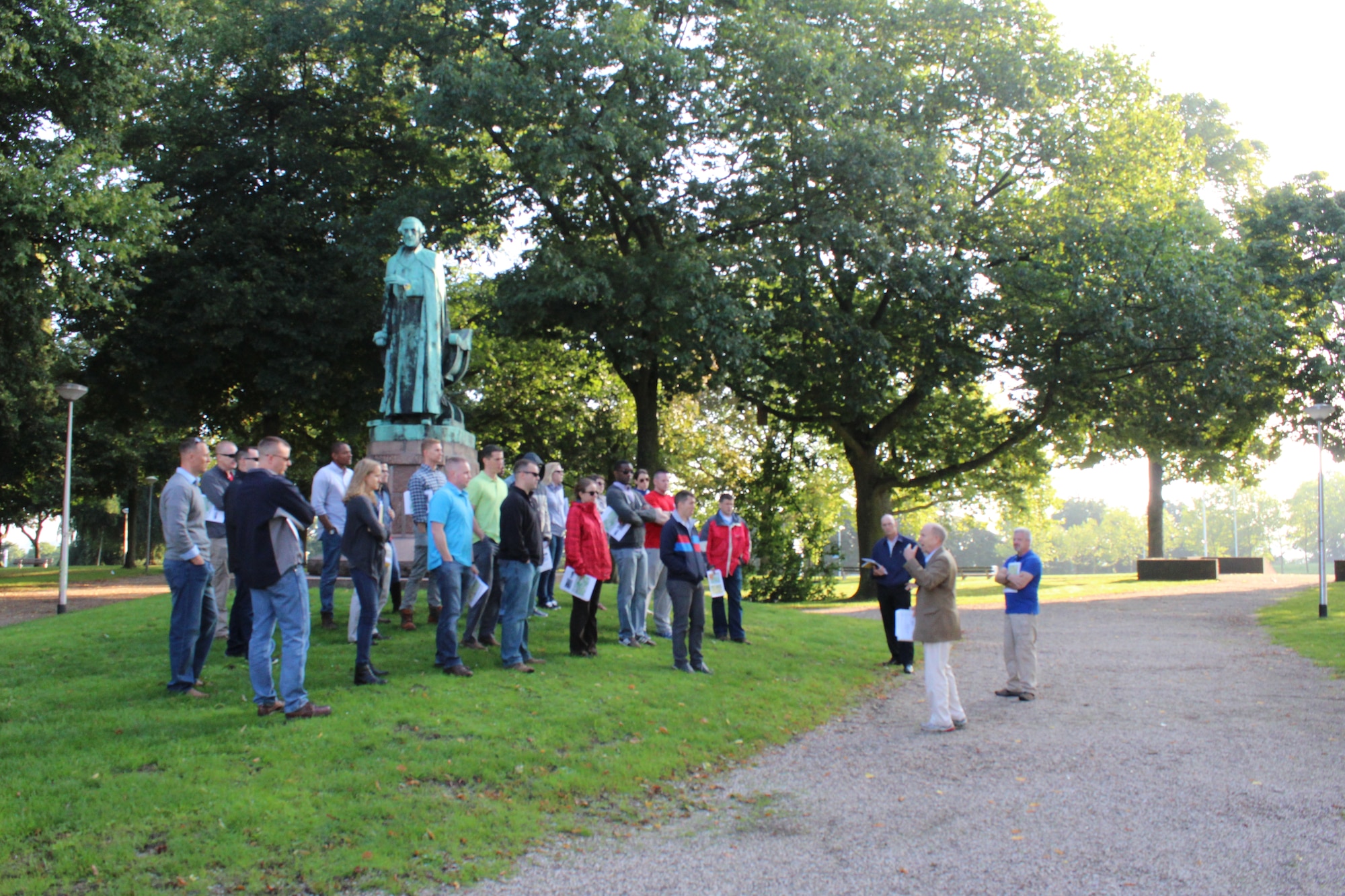 Staff ride participants stand in a park in Nijmegen, Netherlands, Sept. 2, 2015, to hear about a battle between U.S. paratroopers and German SS troops to gain control over the Nijmegen Bridge 71 years earlier in same spot. This park was one of the many places that airmen participating in the Operation Market Garden staff ride stopped to see along their route. The staff ride was part of a series that General Frank Gorenc, Commander, U.S. Air Forces in Europe, U.S. Air Forces in Africa, has organized to foster the deliberate professional development of USAFE-AFAFRICA airmen. (U.S. Air Force photo/ Capt. Lauren Ott)
