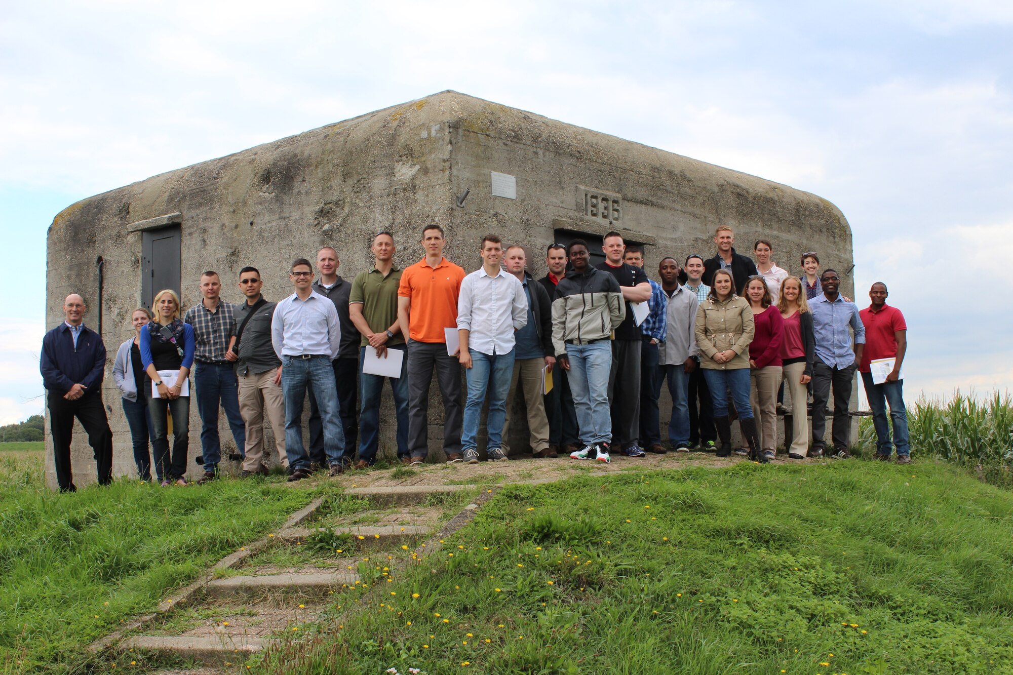 Participants of the Operation Market Garden staff ride gather in front of a pillbox, Sept. 2, 2015, located off to the side of the John S. Thompson Bridge.  This site was one of the many places that airmen participating in the Operation Market Garden staff ride stopped to see along their route. The staff ride was part of a series that General Frank Gorenc, Commander, U.S. Air Forces in Europe, U.S. Air Forces in Africa, has organized to foster the deliberate professional development of USAFE-AFAFRICA airmen. (Courtesy Photo)