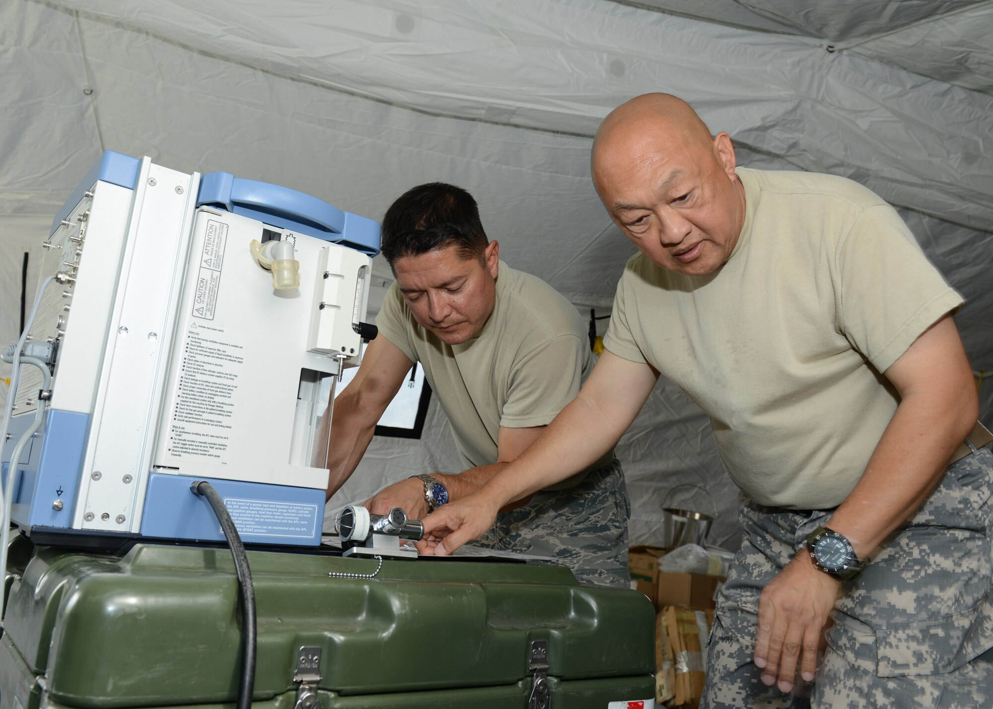 U.S. Air Force Maj. Richard Rogers, 86th Medical Group nurse anesthetist, and U.S Army Maj. William Ang Abrigo, 352nd Combat Support Hospital Alpha Company member, assemble an anesthesia machine at the U.S. Air Forces Expeditionary Medical Support training site in Vipava army base, Slovenia, Sept. 15, 2015. The training is part of the 13-day multinational, tactical field training exercise, Immediate Response 15. The exercise is designed to allow partner nations and U.S. military services to improve NATO interoperability and regional security. (Photo by U.S. Air Force Tech. Sgt. Eric Donner/Released)