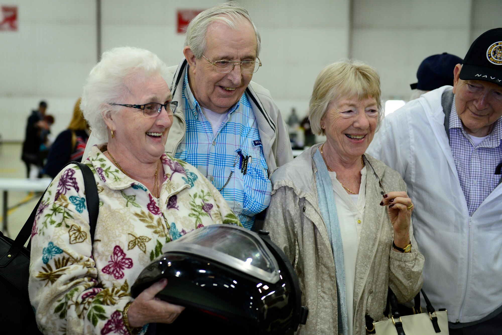 Retirees take turns holding a bomb suit helmet during the 29th annual Retiree Appreciation Day at Royal Air Force Lakenheath, England, Sept. 11, 2015. This event gives active-duty Airmen the opportunity to interact with retirees and pay respects to those who have served before them. (U.S. Air Force photo by Airman 1st Class Erin R. Babis/Released)