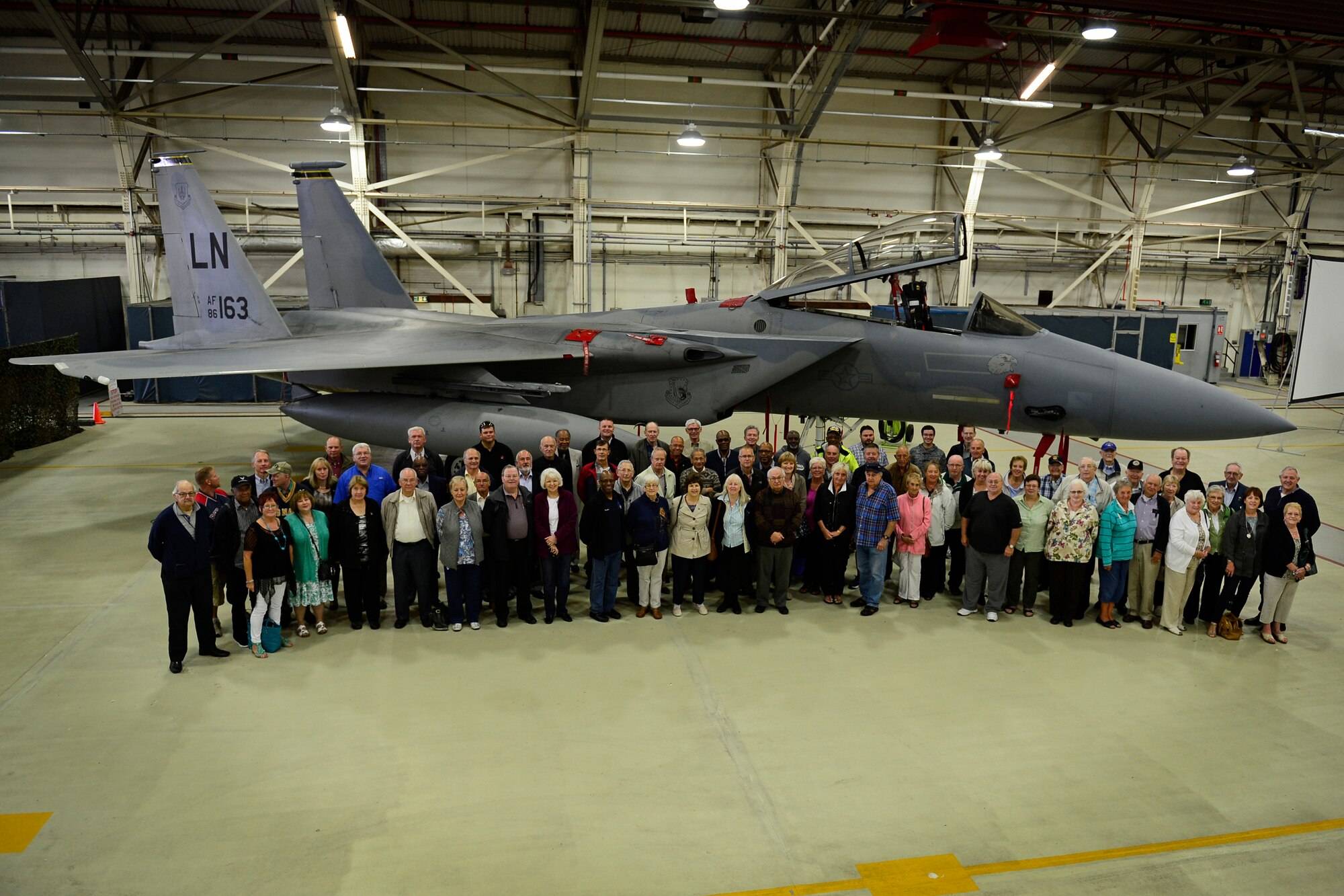 Retirees pose in front of a 493rd F-15C Eagle at the 29th annual Retiree Appreciation Day at Royal Air Force Lakenheath, England, Sept. 11, 2015. Retiree Appreciation Day provides retirees living in the United Kingdom an opportunity to remain up-to-date with events involving active-duty members, medical and dental benefits, as well as other amenities available on the installation. (U.S. Air Force photo by Airman 1st Class Erin R. Babis/Released)