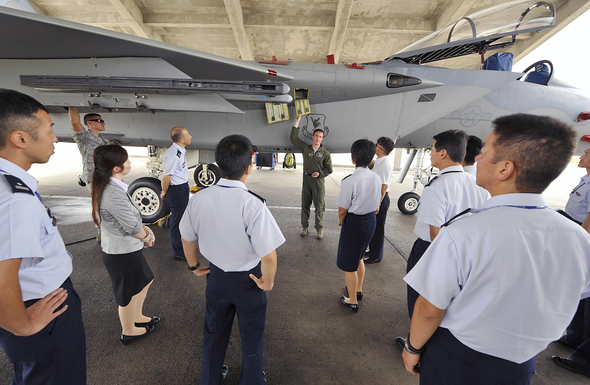 U.S. Air Force Capt. Steven Hendricks, 44th Fighter Squadron F-15 Eagle pilot, explains to Japan Air Self-Defense Force officers the mechanics of an F-15C during their tour of Kadena's aircraft operation facilities Sept. 16, 2015, on Kadena Air Base, Japan. Nine JASDF officers had the opportunity to observe Kadena's aircraft and learn their mission and capabilities. (U.S. Air Force photo by Naoto Anazawa)