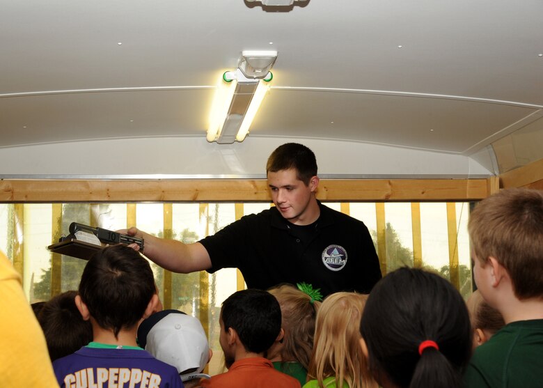 Airman 1st Class Glenn Viner, 319th Civil Engineer Squadron emergency management specialist, waves an alpha probe over the heads of Larimore Elementary School students Sept. 16, 2015, in Larimore, North Dakota. Viner was explained to the students how they check for radiation in case of a natural disaster. Grand Forks Air Force Base Emergency Management was scheduled to make 12 school visits in the local area during National Preparedness Month. (U.S. Air Force photo by Airman 1st Class Ryan Sparks/Released)