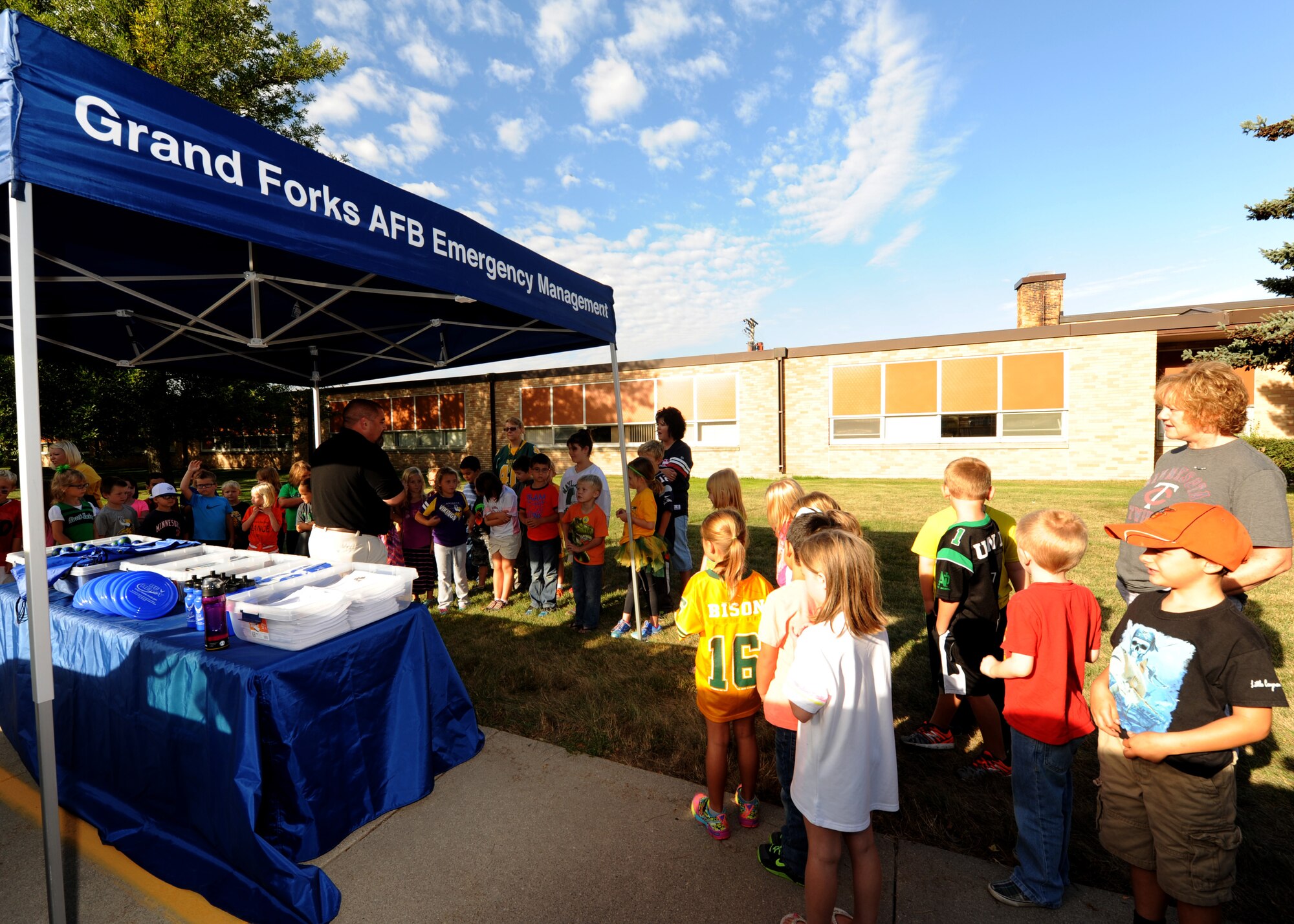 Larimore Elementary School students listen as Shawn W. Leach, 319th Civil Engineer Squadron emergency management specialist, speaks about preparedness Sept. 16, 2015, in Larimore, North Dakota. Grand Forks Air Force Base Emergency Management was scheduled to make 12 school visits in the local area during National Preparedness Month. (U.S. Air Force photo by Airman 1st Class Ryan Sparks/Released)