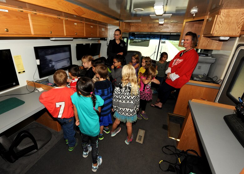 Students from Larimore Elementary School take turns controlling the security camera in a mobile command station Sept. 16, 2015, in Larimore, North Dakota. The emergency management team from Grand Forks Air Force Base, North Dakota visited the school to teach children the basics of preparedness. The team was scheduled to make a total of 12 school visits in the local area in honor of National Preparedness Month. (U.S. Air Force photo by Airman 1st Class Ryan Sparks/Released)