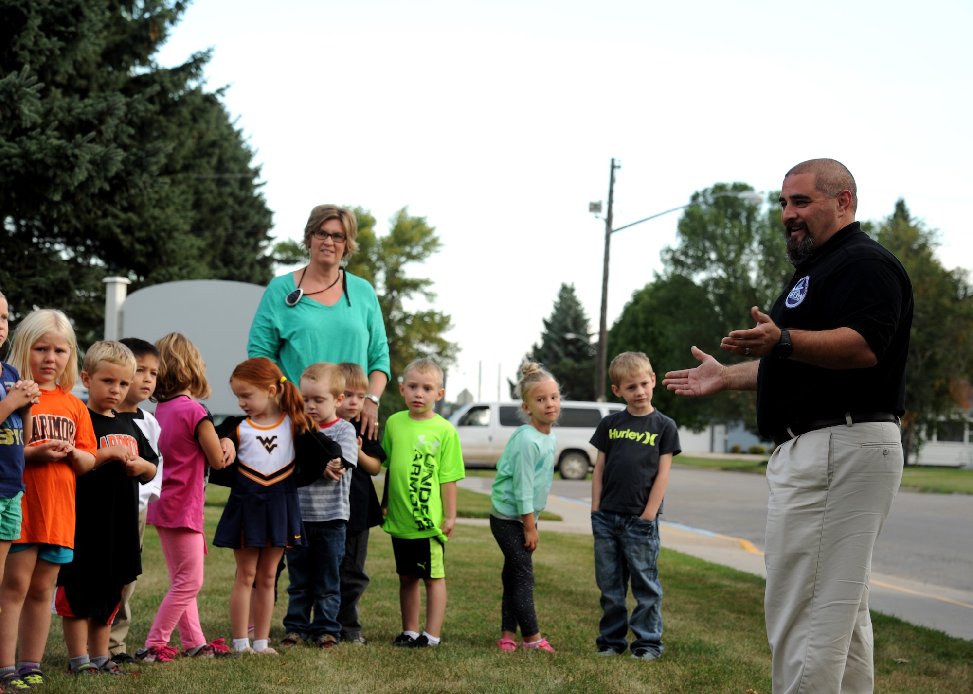 Shawn W. Leach, 319th Civil Engineer Squadron emergency management specialist, addresses a group of kindergarteners at Larimore Elementary School Sept. 16, 2015, in Larimore, North Dakota. The visit was one of 12 visits to local schools meant to educate students on ways to be prepared for natural disasters. (U.S. Air Force photo by Airman 1st Class Ryan Sparks/Released)