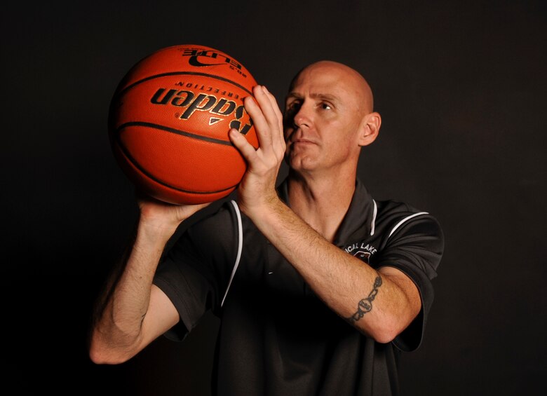 Tech. Sgt. Noel Hachtel, 92nd Logistics Readiness Squadron training and validation office NCO in charge, poses with his basketball Aug. 31, 2015, at Fairchild Air Force Base, Wash. Hachtel volunteers 18 hours a week as a basketball coach for Medical Lake High School. (U.S. Air Force photo/Airman 1st Class Taylor Bourgeous)