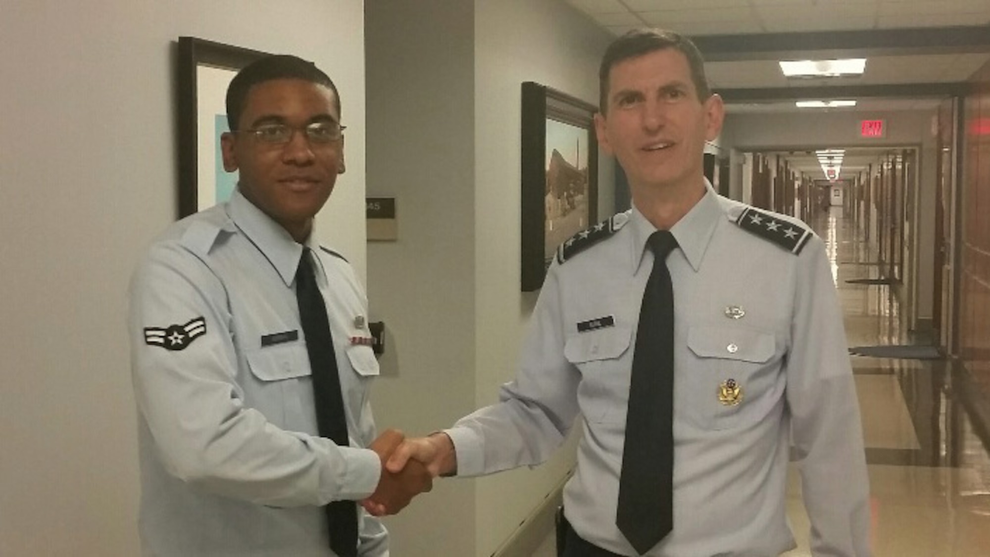 Airman 1st Class Cardell Morgan, 30th SW Judge Advocate civil law paralegal, is recognized by Lt. Gen. Christopher F. Burne, Judge Advocate General of the Air Force, Sept. 8, 2015, Washington, D.C. Morgan was recently selected to attend a trip to Capitol Hill with Col. Christopher Moss, 30th Space Wing commander and Chief Master Sgt. Robert Bedell, 30th SW command chief, to meet with Congressional representatives for the Central Coast. (courtesy photo)