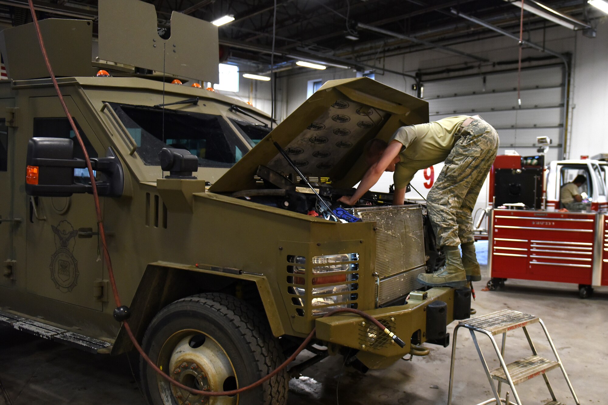 Airman 1st Class Montgomery Martinson, 341st Logistics Readiness Squadron vehicle maintenance technician, installs a radiator into a Bearcat Sept. 15, 2015, at Malmstrom Air Force Base, Mont. An average of 14 personnel at the heavy equipment shop upkeep these vehicles year-round, sometimes pulling 12-hour shifts for 24-hours. (U.S. Air Force photo/Chris Willis)