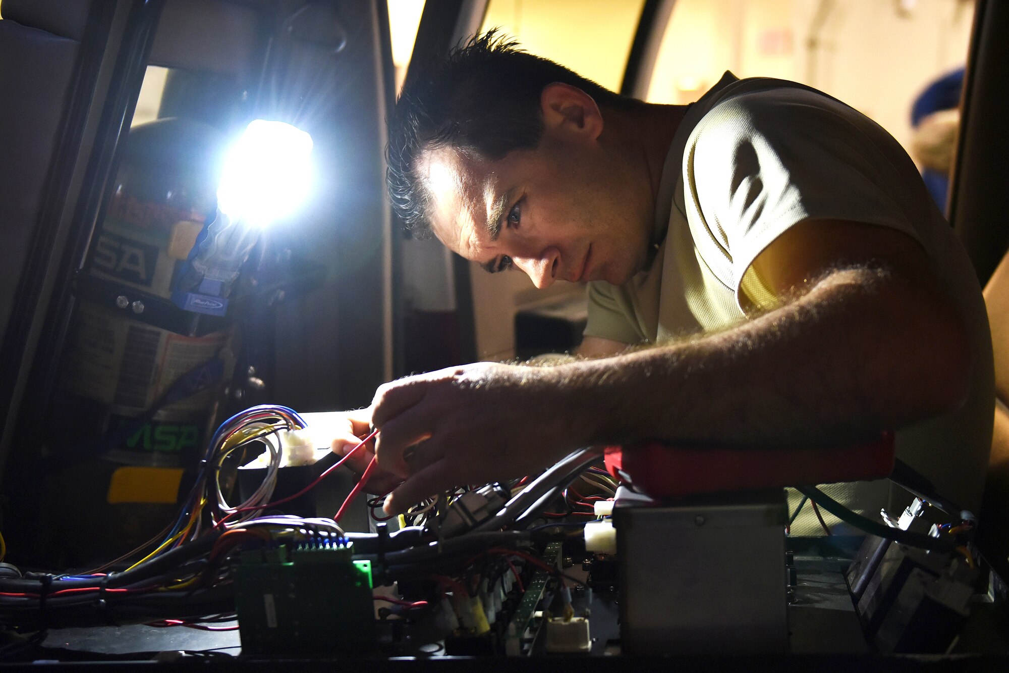 Staff Sgt. Benjamin Duke, 341st Logistics Readiness Squadron vehicle maintenance technician, trouble shoots wiring for an ignition shift to a fire truck Sept. 15, 2015, at Malmstrom Air Force Base, Mont. An average of 14 personnel at the heavy equipment shop upkeep these vehicles year-round, sometimes pulling 12-hour shifts for 24-hours. (U.S. Air Force photo/Chris Willis)