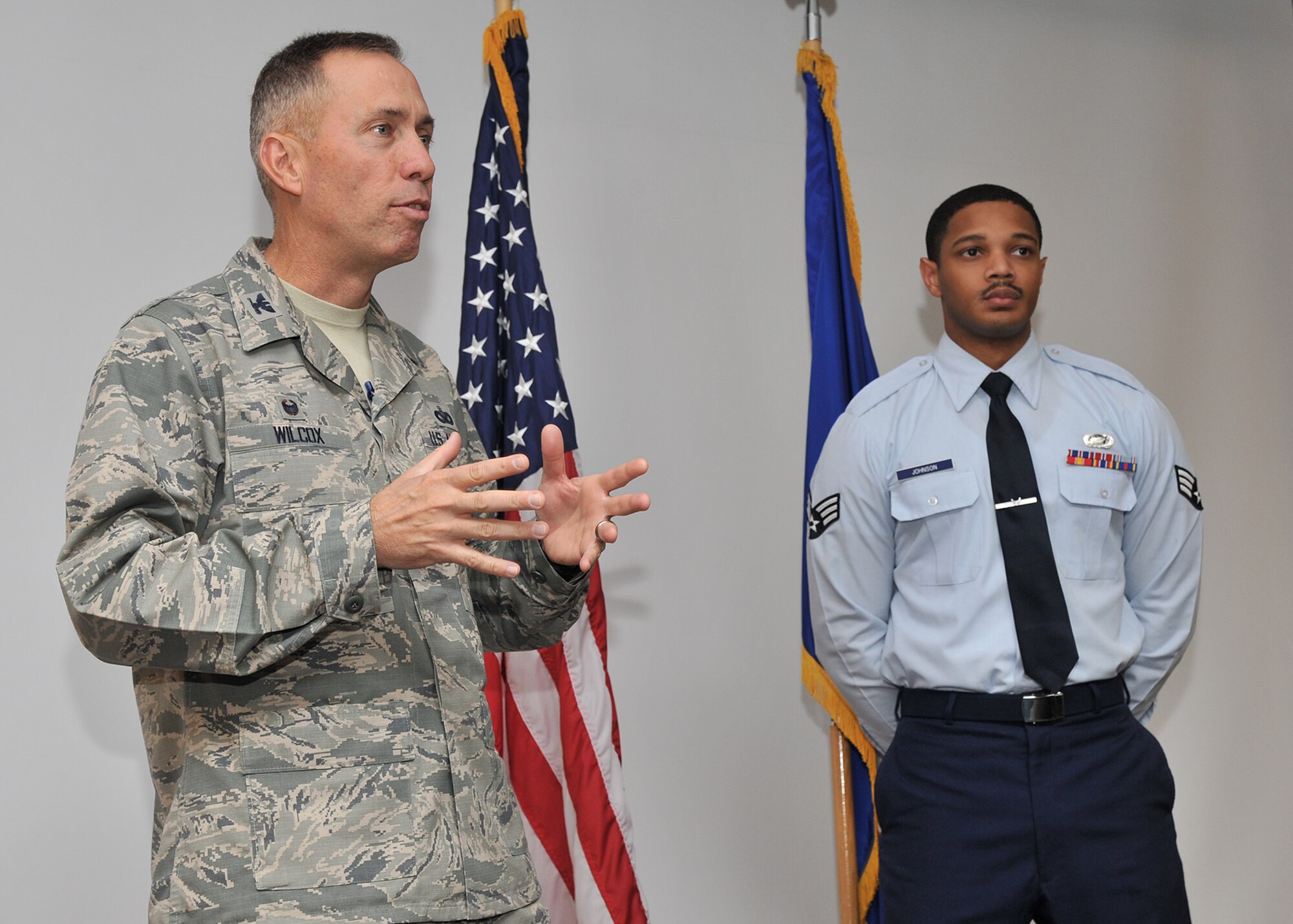 Col. Tom Wilcox, 341st Missile Wing commander, left, addresses the actions of Senior Airman Thaddeus Johnson, 341st Force Support Squadron customer support apprentice, before presenting him with a coin Sept. 2, at Malmstrom Air Force Base, Mont. Johnson displayed exemplary wingmanship traits and adherence to the Air Force core values by helping a fellow Airman during his time of need. (U.S. Air Force photo/John Turner) 