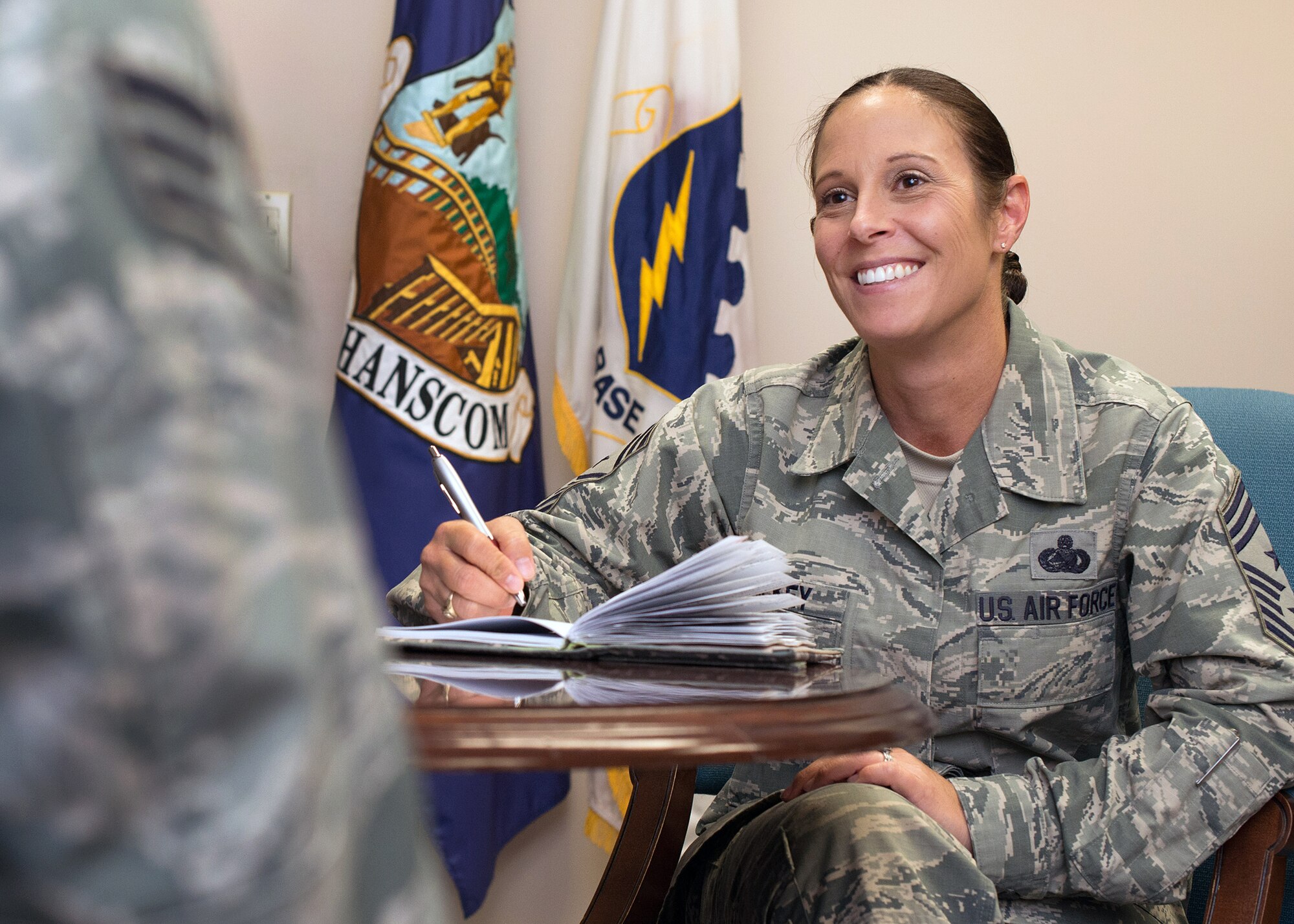 Chief Master Sgt. Patricia Hickey discusses her schedule with Senior Airman Justin Spence, executive assistant to the command chief, in Building 1305 Sept. 10. Hickey is the command chief for the 66th Air Base Group and Hanscom Air Force Base, Mass. (U.S. Air Force photo by Mark Herlihy)
