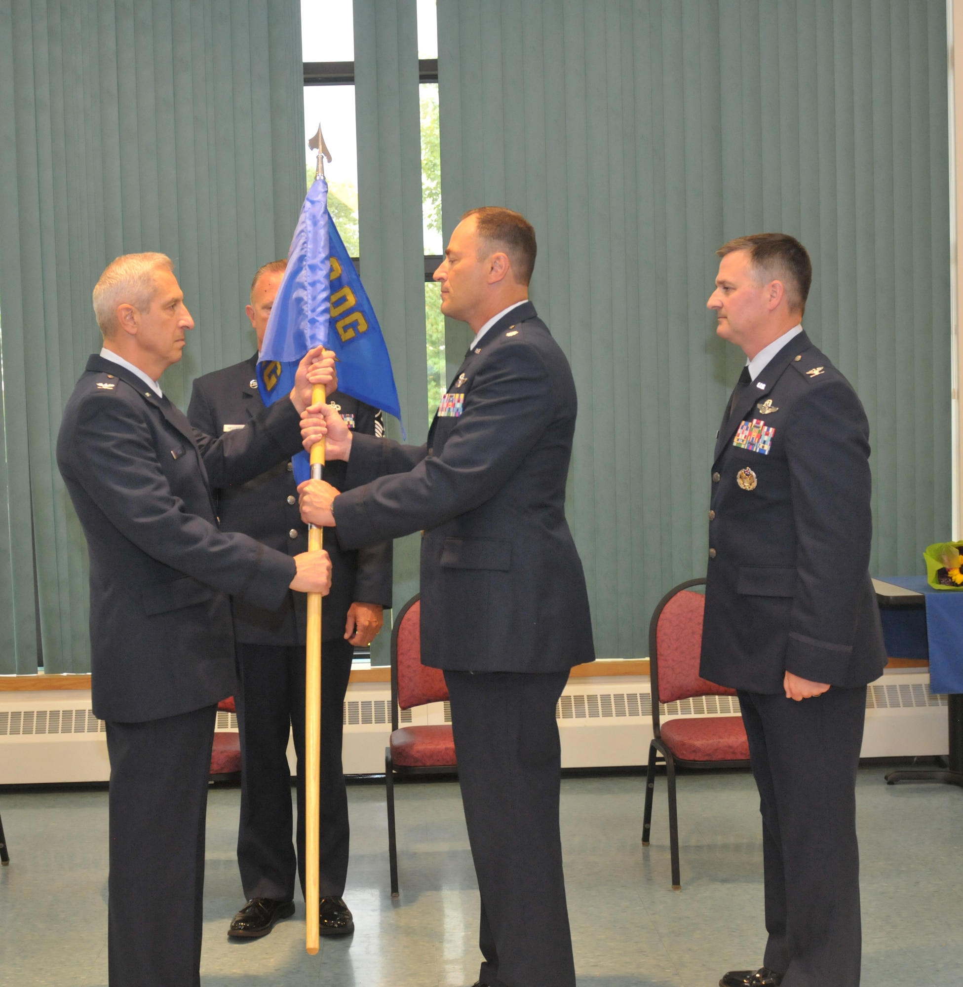 Lt. Col. Chris Sander assumed command of the 109th Operations Group from outgoing commander Col. Michael Steindl (right) with Col. Alan Ross (left), 109th Airlift Wing vice commander, officiating the change of command ceremony at Stratton Air National Guard Base, New York, on Sept. 13, 2015. Sander was previously the 109th Maintenance Group deputy commander. (U.S. Air National Guard photo by Master Sgt. William Gizara/Released)