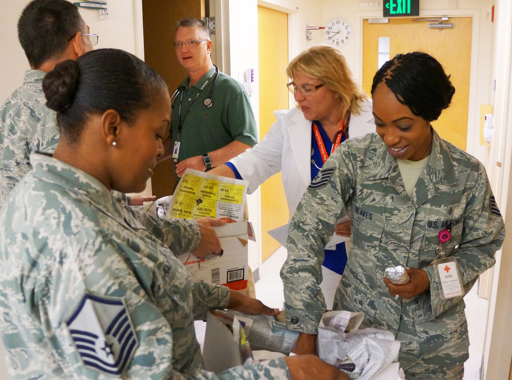 Chapel staff members hand out burritos to members of the 78th Medical Group. The Base Chapel staff visited various units Aug. 25 to pass out breakfast burritos. The project was a way to not only reach out to units across base but also to boost morale. The workers began making 400 burritos at 5 a.m.(U.S. Air Force photo by Ed Aspera)