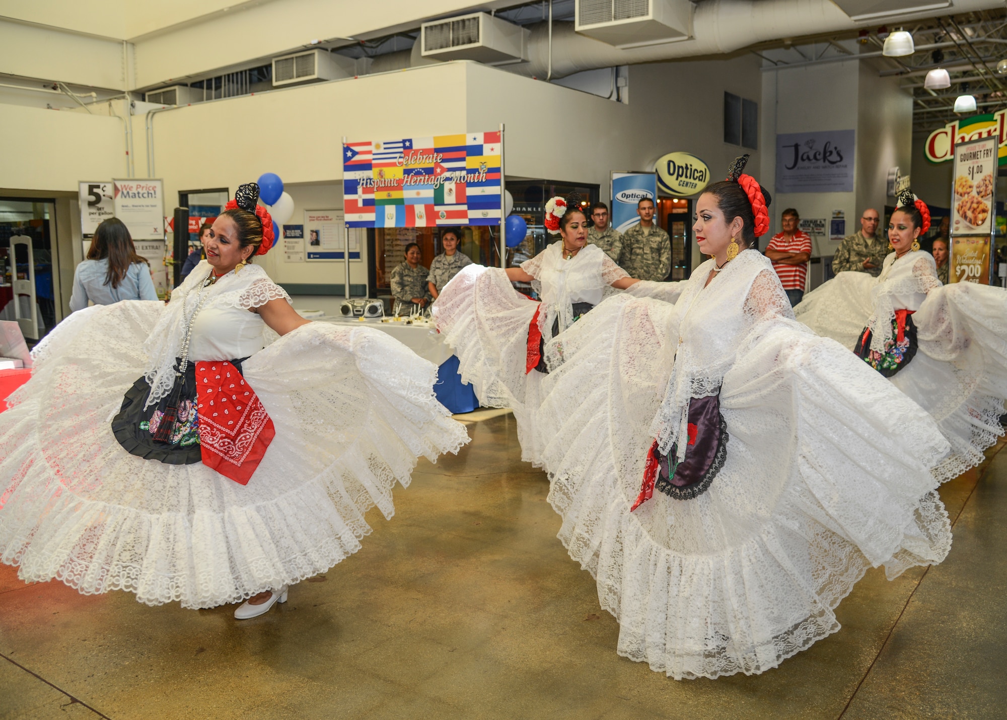 Wearing traditional gowns, the group performed several dances from the State of Veracruz. In one of the dances, “La Bamba,” the dance partners tie a bow using their feet to represent the unity of marriage. While the Ballet Folklorico Etzatlan is an all-female group, the dance is traditionally performed by a man and a woman. (U.S. Air Force photo by Rebecca Amber)