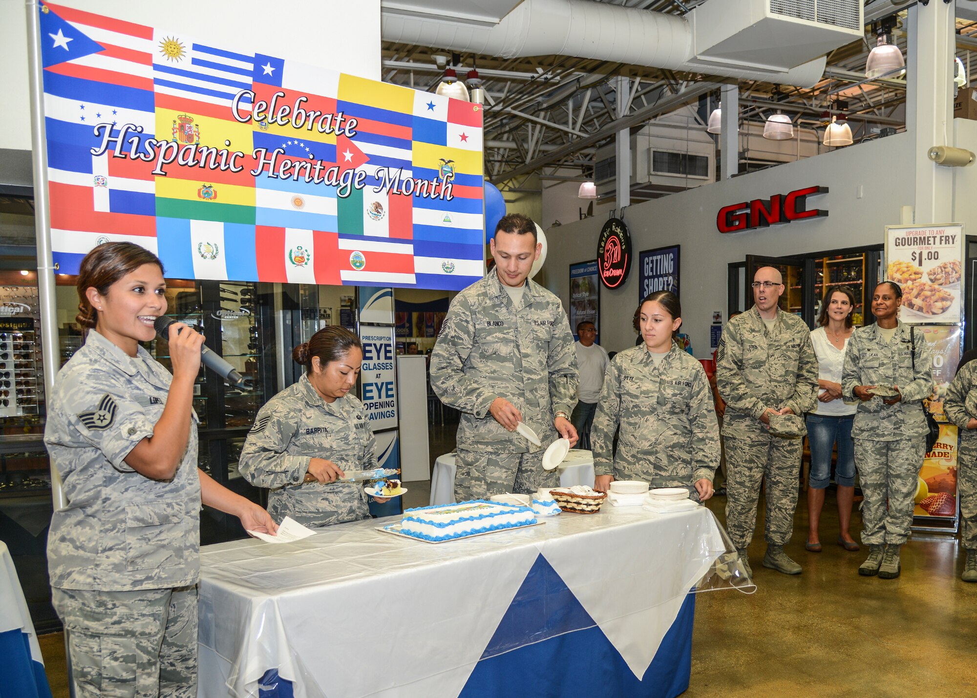 Staff Sgt. DeAnn Lopez (left), 412th Medical Group, introduces the opening ceremony for Hispanic Heritage Month at the Base Exchange Sept. 15. (U.S. Air Force photo by Rebecca Amber)