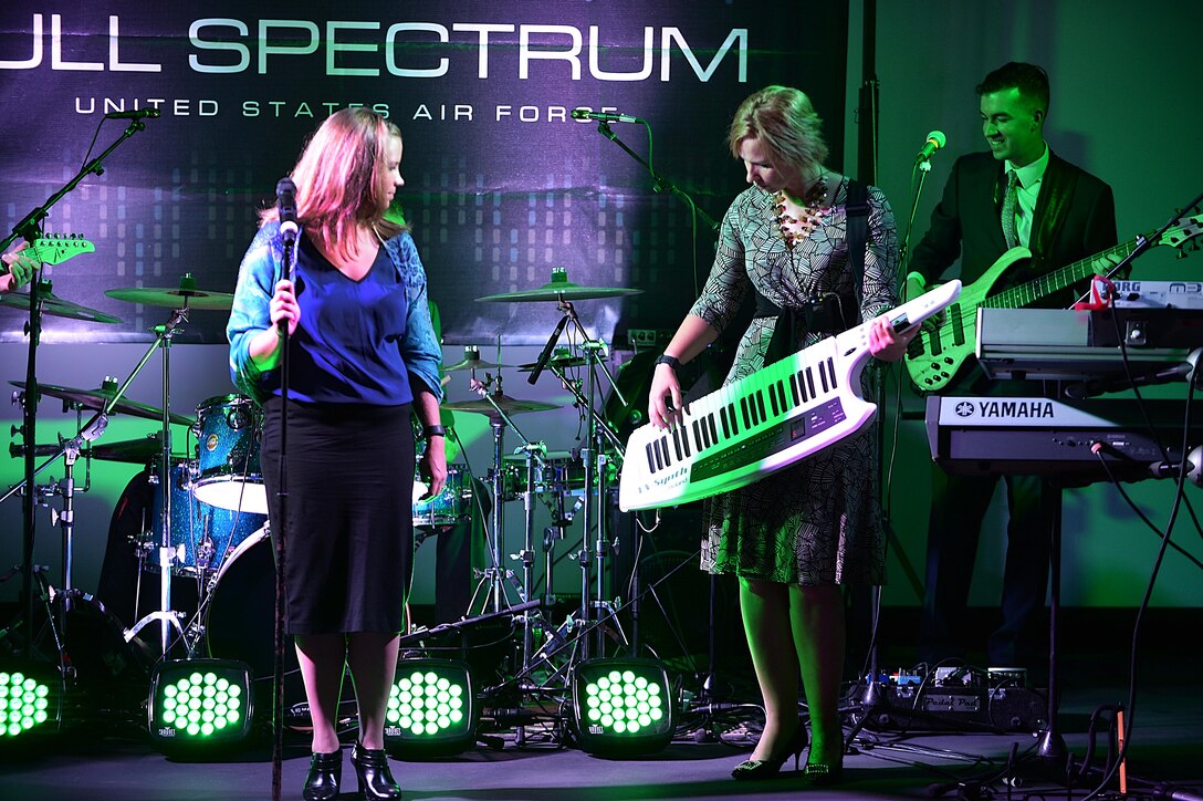 Senior Airman Melissa Lackore, left, and Staff Sgt. Michelle Hooper, Air Forces Central Command band members performs during a concert for students at the Qatar Academy, Doha, Qatar, Sept. 14, 2015. With different priorities as a deployed band, the musicians work to reach as many people as possible to keep spirits high everywhere they go. (U.S. Air Force photo by Staff Sgt. Emerson Nuñez/Released)
