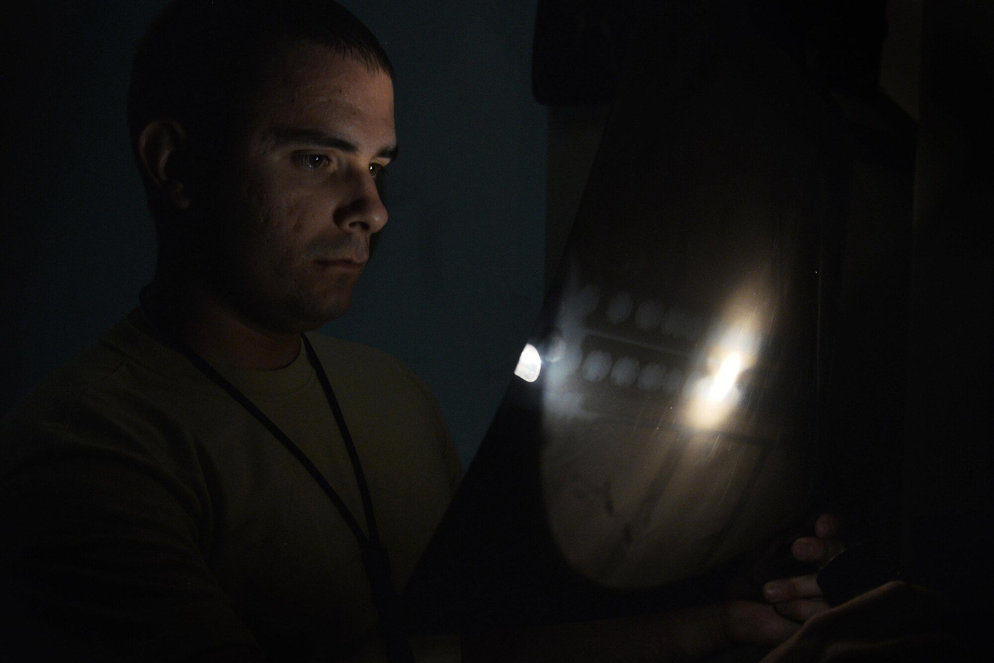 Senior Airman Christopher reviews an X-ray of an F-15E for cracks at an undisclosed location in Southwest Asia September 15, 2015. Nondestructive inspection uses X-rays to look inside aircrafts to identify damage. Christopher is a nondestructive inspection journeyman assigned to the 380th Expeditionary Maintenance Squadron. (U.S. Air Force photo/Tech. Sgt. Christopher Boitz)