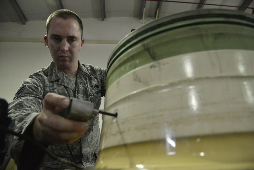 To scan for defects, Staff Sgt. Logan uses a bolt hole eddy current probe to scan the inside of a fuse plug hole on a wheel at an undisclosed location in Southwest Asia September 15, 2015. Logan is the assistant noncommissioned officer in charge of nondestructive inspection assigned to the 380th Expeditionary Maintenance Squadron. (U.S. Air Force photo/Tech. Sgt. Christopher Boitz)