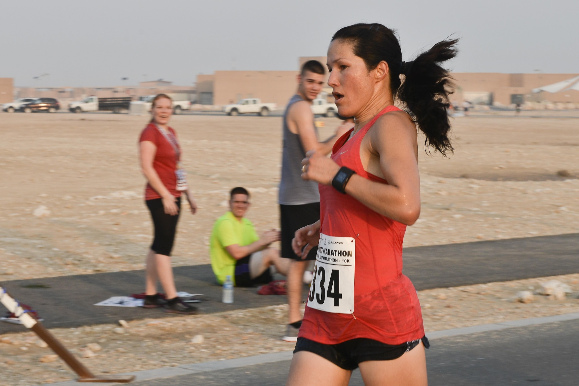Capt. Alycia Hackenburg, Air Force Central Command, crosses the finish line as the first female to complete 13.1 miles at the 2015 Air Force Marathon Forward September 13, 2015 at Al Udeid Air Base, Qatar. This will mark seven years that the race has taken place at seven operating bases in theater. The first Air Force Marathon was held in 1997 at Wright-Patterson Air Force Base, Ohio. Since then, each marathon has been held the third Saturday of September, with an aircraft chosen each year to represent Air Force history in flight. (U.S. Air Force photo/ Staff Sgt. Alexandre Montes) 