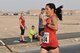 Capt. Alycia Hackenburg, Air Force Central Command, crosses the finish line as the first female to complete 13.1 miles at the 2015 Air Force Marathon Forward September 13, 2015 at Al Udeid Air Base, Qatar. This will mark seven years that the race has taken place at seven operating bases in theater. The first Air Force Marathon was held in 1997 at Wright-Patterson Air Force Base, Ohio. Since then, each marathon has been held the third Saturday of September, with an aircraft chosen each year to represent Air Force history in flight. (U.S. Air Force photo/ Staff Sgt. Alexandre Montes) 