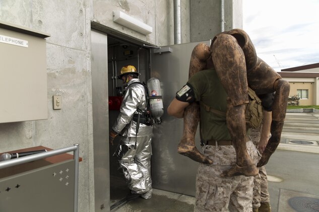 Marines and firefighters climbed the training tower during a 9/11 remembrance climb aboard Marine Corps Air Station Iwakuni, Japan, Sep. 9, 2015, to honor those who lost their lives on 9/11. Participants included Aircraft Rescue and Firefighting, the Provost Marshal's Office and the Special Reaction Team Marines with Headquarters and Headquarters Squadron, Fuel Division Marines with Marine Wing Support Squadron 171, and Japanese firefighters. Each participant carried with them a photo of a fallen firefighter as they climbed the training towers 18 times for a total of 110 floors, the same amount of floors as the twin towers.