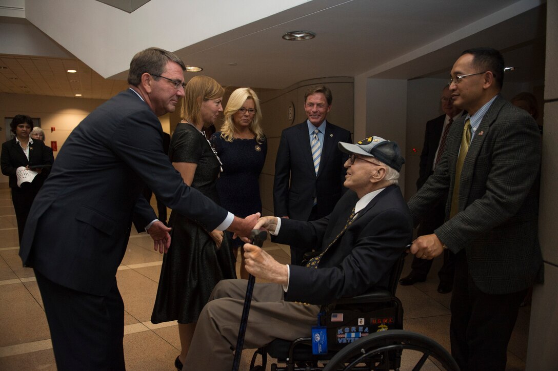 Defense Secretary Ash Carter shakes hands with Korean War veteran Joseph Krebs as he arrives at the Ronald Reagan Building and International Trade Center for the Fisher House's 25th Anniversary Gala in Washington, D.C., Sept. 16, 2015. DoD photo by U.S. Air Force Senior Master Sgt. Adrian Cadiz