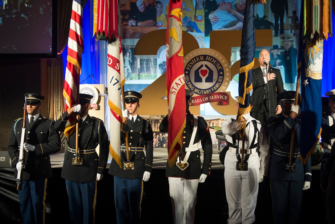 A joint color guard presents the colors as Franc D'Ambrosio sings the national anthem during the Fisher House's 25th Anniversary Gala at the Ronald Reagan Building and International Trade Center in Washington, D.C., Sept. 16, 2015. DoD photo by U.S. Air Force Senior Master Sgt. Adrian Cadiz