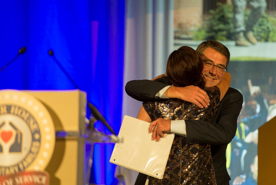 Defense Secretary Ash Carter hugs CNN anchor and mistress of ceremonies, Kyra Phillips, as she introduces him as the event's guest speaker during the Fisher House's 25th Anniversary Gala at the Ronald Reagan Building and International Trade Center in Washington, D.C., Sept. 16, 2015. DoD photo by U.S. Air Force Senior Master Sgt. Adrian Cadiz