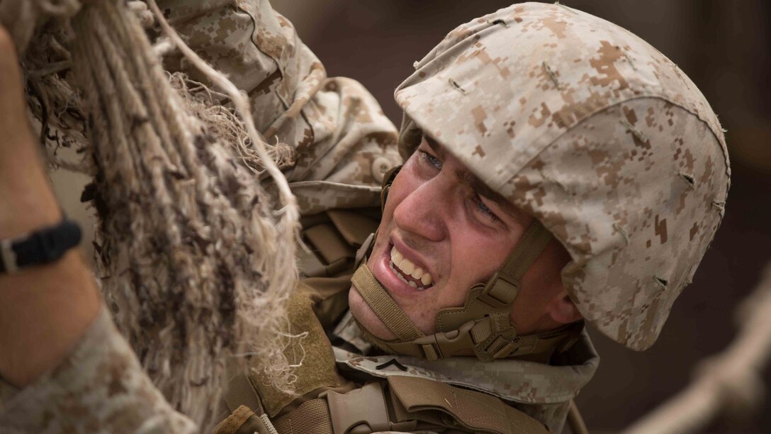 Pfc. Benjamin Austin, an assaultman, with Bravo Company, 1st Battalion, 3rd Marine Regiment and St. Louis, Mo. native, holds his body weight up while attempting to untie a rope while completing the Leadership Reaction Course at Training Area Boondocker aboard Marine Corps Base Hawaii, Sept. 15, 2015. The LRC empowers small unit leaders by putting squads in difficult situations that can only be accomplished through teamwork. Bravo Company was conducting sustainment training to ensure they keep their combat mindset sharp and intact before embarking on their upcoming Unit Deployment Program. Training like this supports the mission of Marine Corps Base Hawaii by enhancing and sustaining combat readiness. 