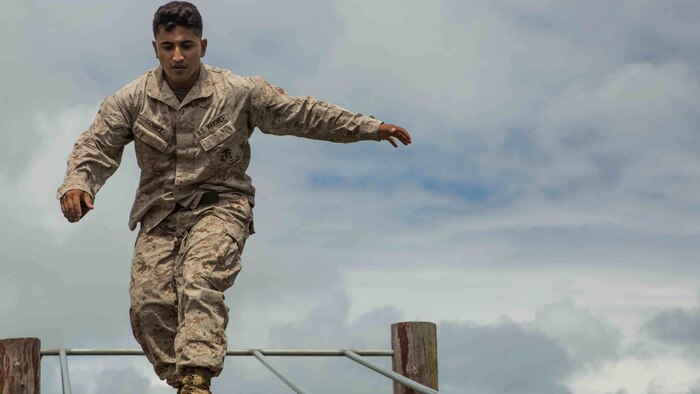 Cpl. Jacob Gomez, a rifleman with Bravo Company, 1st Battalion, 3rd Marine Regiment and a Lubbock, Texas native, walks across a log while running through the obstacle course at Boondocker Training Area aboard Marine Corps Base Hawaii, Sept. 15, 2015. Marines from Bravo Co. 1st Bn., 3rd Marines conducted sustainment training to ensure they keep their combat mindset sharp and intact before embarking on their upcoming Unit Deployment Program. Training like this supports the mission of Marine Corps Base Hawaii by enhancing and sustaining combat readiness. 