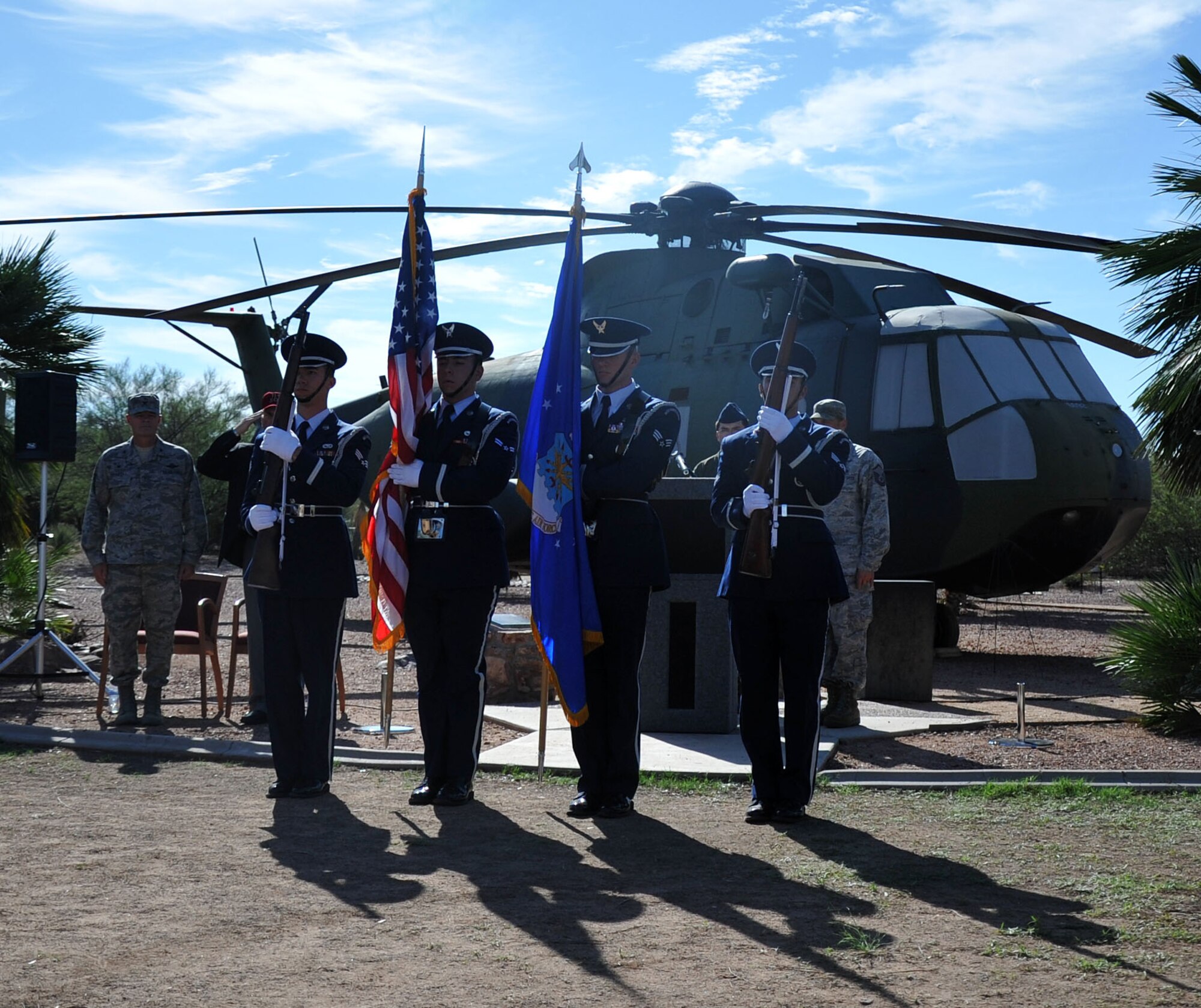The Davis-Monthan Air Force Base Honor Guard prepare to posts the Colors at a memorial ceremony in honor of the 15 men who died in the crash of PONY 1-2 March 12, 1989. The ceremony was held at Heritage Park on Davis-Monthan AFB at Heritage Park in front of a static display of CH-3E Jolly Green Giant helicopter similar to the own flown by the aircrew of flight PONY 1-2. (U.S. Air Force Photo/ Tech. Sgt. Carolyn Herrick)