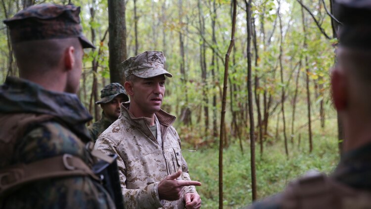 Col. Morgan G. Mann, deputy commander of 25th Marine Regiment, 4th Marine Division, Marine Forces Reserve, speaks to Marines with Co. C, 1st Battalion, 25th Marines, and members of the Canadian Army Royal Hamilton Light Infantry, Wentworth Regiment, after a patrolling engagement with another platoon Sept. 12, 2015, during Exercise Lake Effect. Mann commented on the way the Marines and Canadians reacted to an ambush assault by another platoon.