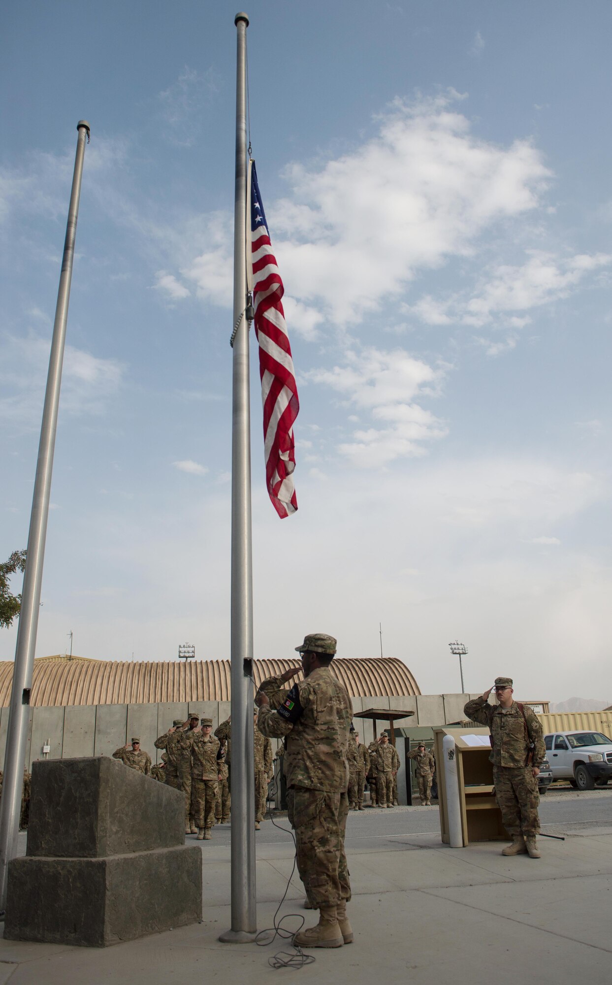 U.S. Airmen with the Bagram Airfield Honor Guard lower the U.S. Flag during the Prisoners Of War, Missing In Action Remembrance and Retreat Ceremony at BAF, Afghanistan, Sept. 17, 2015. The ceremony was in honor of National POW/MIA Remembrance Day, which is observed annually in the United States on the third Friday of September. (U.S. Air Force photo by Tech. Sgt. Joseph Swafford/Released)