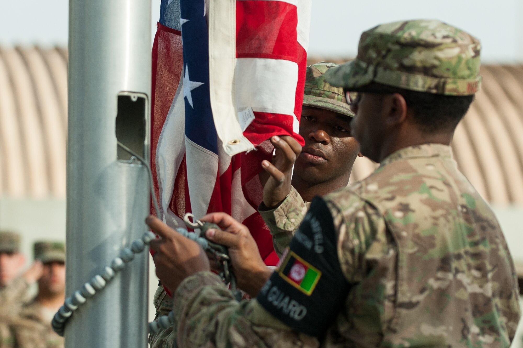 U.S. Airmen with the Bagram Airfield Honor Guard lower the U.S. Flag during the Prisoners Of War, Missing In Action Remembrance and Retreat Ceremony at BAF, Afghanistan, Sept. 17, 2015. The ceremony was in honor of National POW/MIA Remembrance Day, which is observed annually in the United States on the third Friday of September. (U.S. Air Force photo by Tech. Sgt. Joseph Swafford/Released)