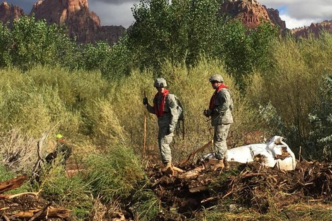 Utah Army National Guardsmen conduct their search and rescue efforts for survivors following the deadly flooding near the border town of Hildale, Utah, Sept. 16, 2015.
