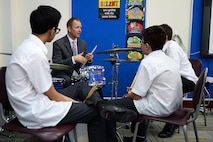 Tech. Sgt. Bennett Weidemann, Air Forces Central Command band drummer, teaches students about drumming during a mentoring session at the Qatar Academy, Doha, Qatar, Sept. 14, 2015. In addition to performing throughout the day, the Airmen answered questions about being professional musicians in the Air Force and held a mentoring session for aspiring musical students. (U.S. Air Force photo by Staff Sgt. Emerson Nuñez/Released)
