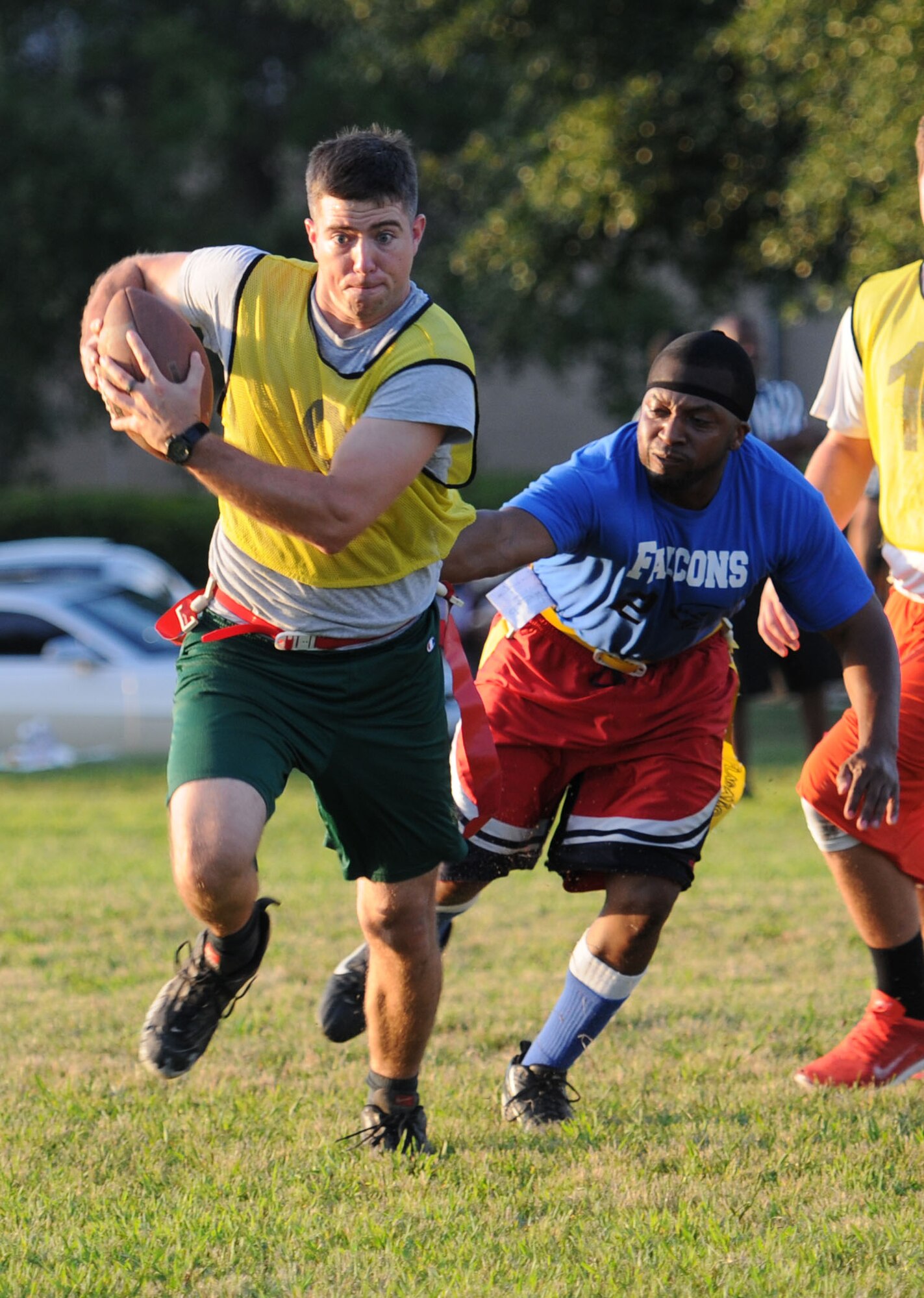 Capt. Jesse Payne, 81st Medical Operations Squadron, runs the ball as Master Sgt. Orlando Thomas, 81st Training Support Squadron, reaches for his flags during an intramural flag football scrimmage Sept. 15, 2015, Keesler Air Force Base, Miss. The season began Sept. 9 and runs through mid-November. (U.S. Air Force photo by Kemberly Groue)