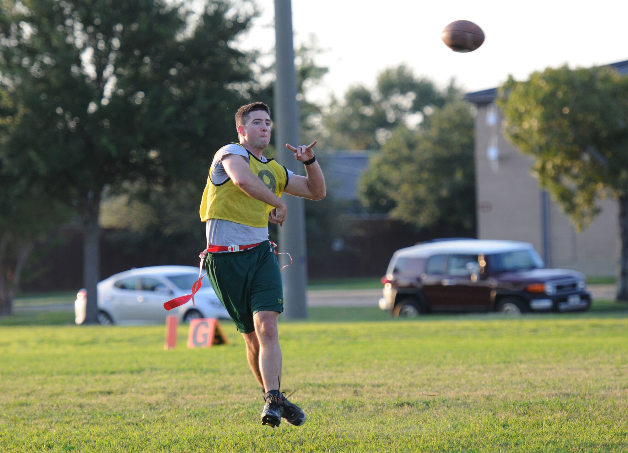 Capt. Jesse Payne, 81st Medical Operations Squadron, throws a pass to a teammate during an intramural flag football scrimmage Sept. 15, 2015, Keesler Air Force Base, Miss. The season began Sept. 9 and runs through mid-November. (U.S. Air Force photo by Kemberly Groue)