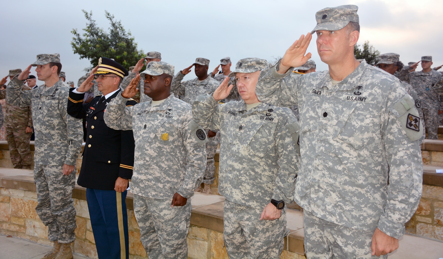 Members and friends of the U.S. Army Medical Service Corps salute during the playing of the National Anthem at the  US Army Medical Service Corps 9/11 Remembrance Ceremony at the Fort Sam Houston National Cemetery, held in honor of the Medical Service Corps officers who paid the ultimate sacrifice as a result of the terrorist attack on Sept. 11, 2001 and in support of combat operations.  