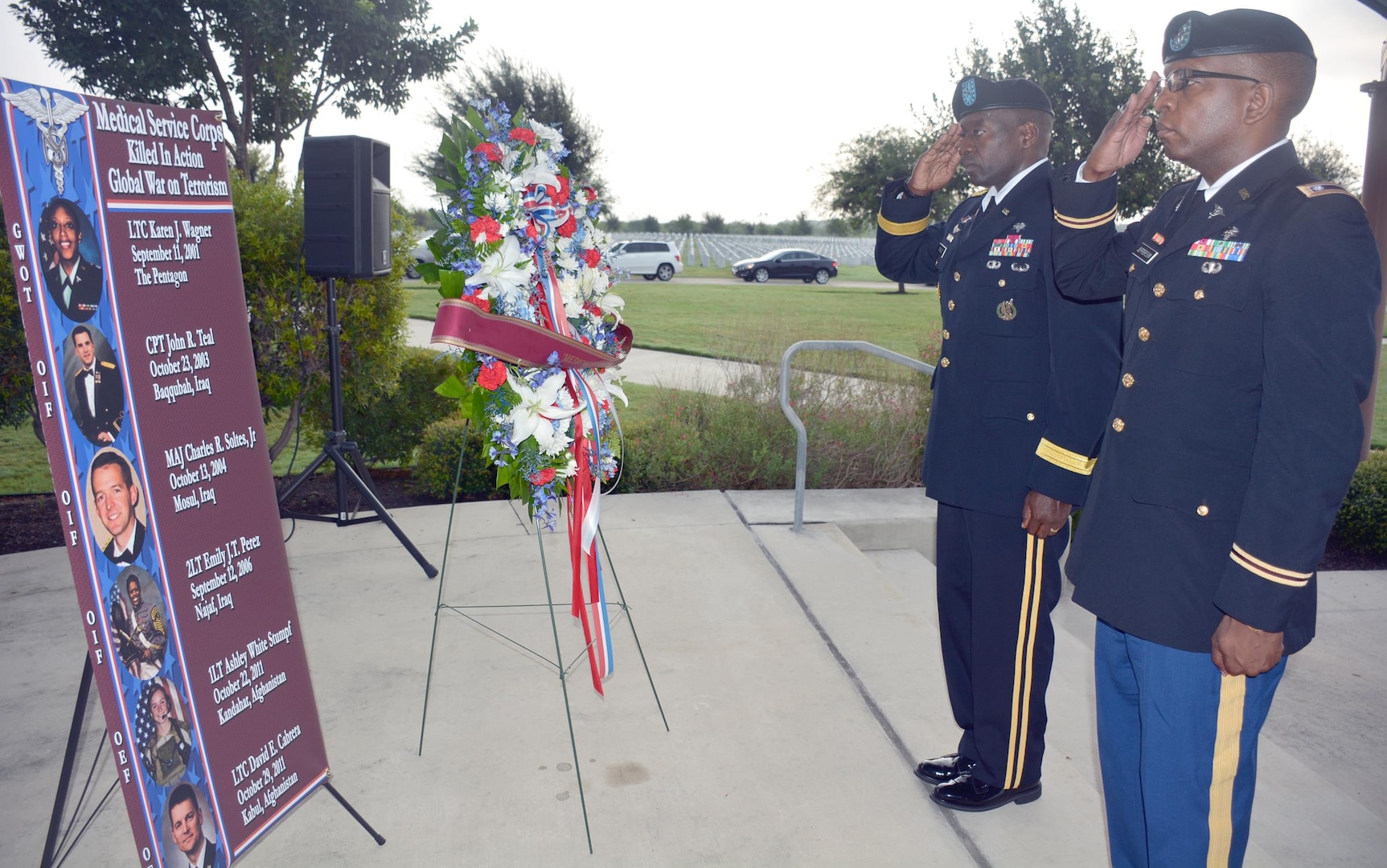 Brig. Gen. R. Scott Dingle (left), U.S. Army Medical Command deputy chief of staff for operations, and Lt. Col. Marion Jefferson, executive officer, Office of the Chief, Medical Service Corps, salute to the sounds of taps during the presentation of a wreath in honor of fallen Medical Service Corps officers at a Sept. 11 remembrance ceremony held at the Fort Sam Houston National Cemetery.