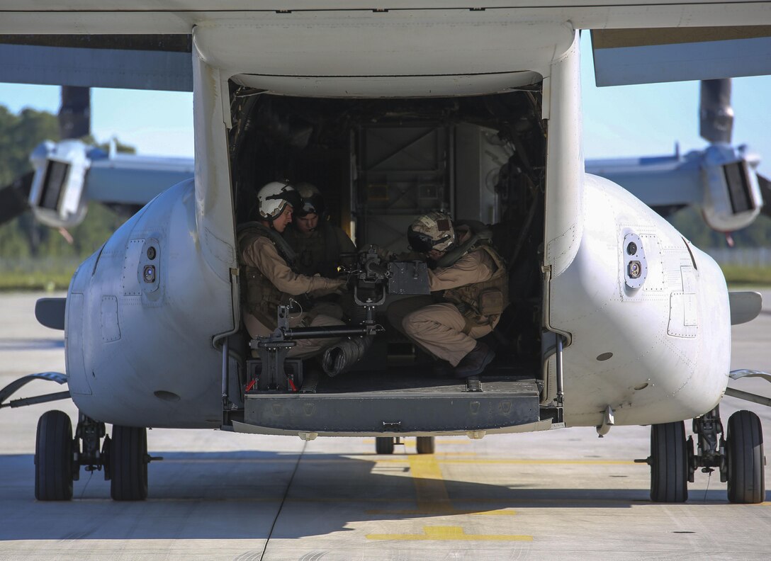 Marines with Marine Medium Tiltrotor Squadron 365 assemble a GAU-16 .50 caliber machine gun on the ramp of an MV-22B Osprey at Marine Corps Air Station New River, N.C., Sept. 15, 2015. Crew chiefs honed their proficiency with the weapon system to be better qualified for future air operations. 