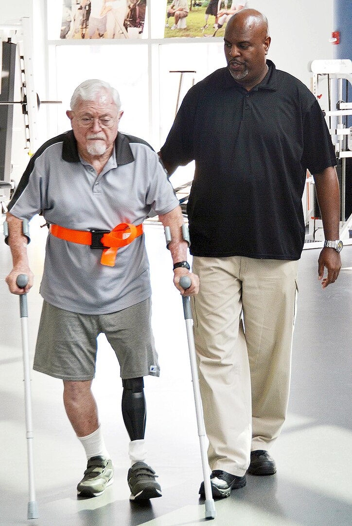 Physical therapy technician Troy Hopkins assists retired Maj. Gen. William L. Moore Jr. at the Center for the Intrepid, Brooke Army Medical Center’s outpatient rehabilitation facility on Fort Sam Houston Sept. 3.