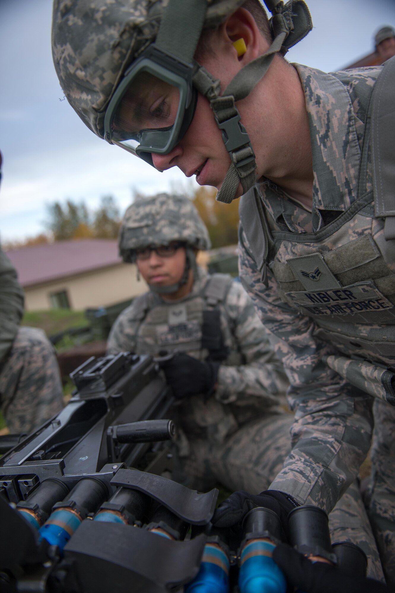 Airman 1st Class Nathaniel Kibler, a 354th Security Forces Squadron response force member, loads a belt of rounds into a Mark 19 grenade launcher Sept. 9, 2015, at Eielson Air Force Base, Alaska. The weapon, which was first developed in the Vietnam War, takes two Airmen to operate, one to load and one to fire. (U.S. Air Force photo by Staff Sgt. Shawn Nickel/Released)