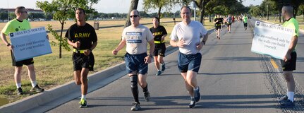 Brig. Gen. Bob LaBrutta, 502nd Air Base Wing and Joint Base San Antonio commander, and 502nd ABW Command Chief Stanley Cadell (center), were joined by hundreds of military members, civilian personnel and family members, as they run down Stanley Road during the 2015 5K Run For Life at JBSA-Fort Sam Houston Sunday. Another run took place at Eberle Park on JBSA-Randolph Saturday and the final run is at the Gillum Fitness Center on JBSA-Lackland, with free registration at 7 a.m. and the run beginning at 8 a.m. Sept. 26. The events promote awareness of the resources available to assist service members and their families with fitness, resiliency and suicide prevention. The top three male and female runners will win awards and all participants receive an “I Run For Life” reflective belt and finisher’s dog tag, while supplies last. For more information, visit http://www.facebook.com/JBSArunforlife and http://www.facebook.com/JointBaseSanAntonio.