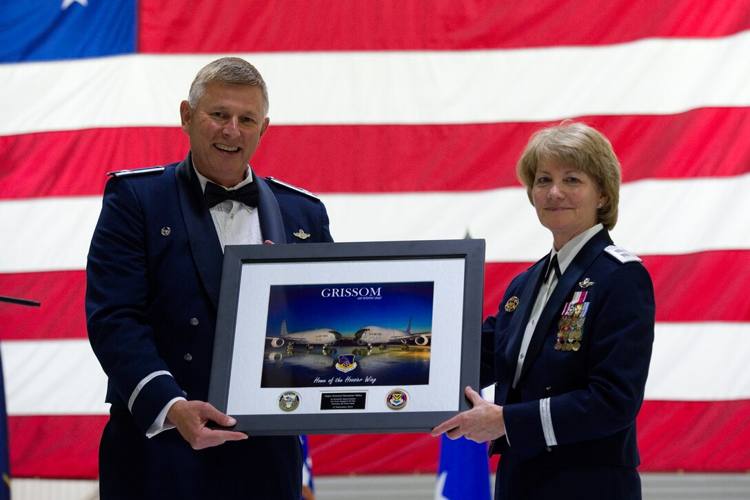 Col. Doug Schwartz, 434th Air Refueling Wing commander, presents Maj. Gen. Maryanne Miller, Headquarters U.S. Air Force deputy to the chief of the Air Force Reserve and guest speaker, a token of appreciation from Team Grissom during an Air Force Ball at Grissom Air Reserve Base, Ind., Sept. 12, 2015. This year’s ball, “Wings over America: A salute to the 1940s” featured music and festivities from that era inside a hangar transformed with authentic World War II memorabilia.  (U.S. Air Force Photo/Tech. Sgt. Benjamin Mota)

