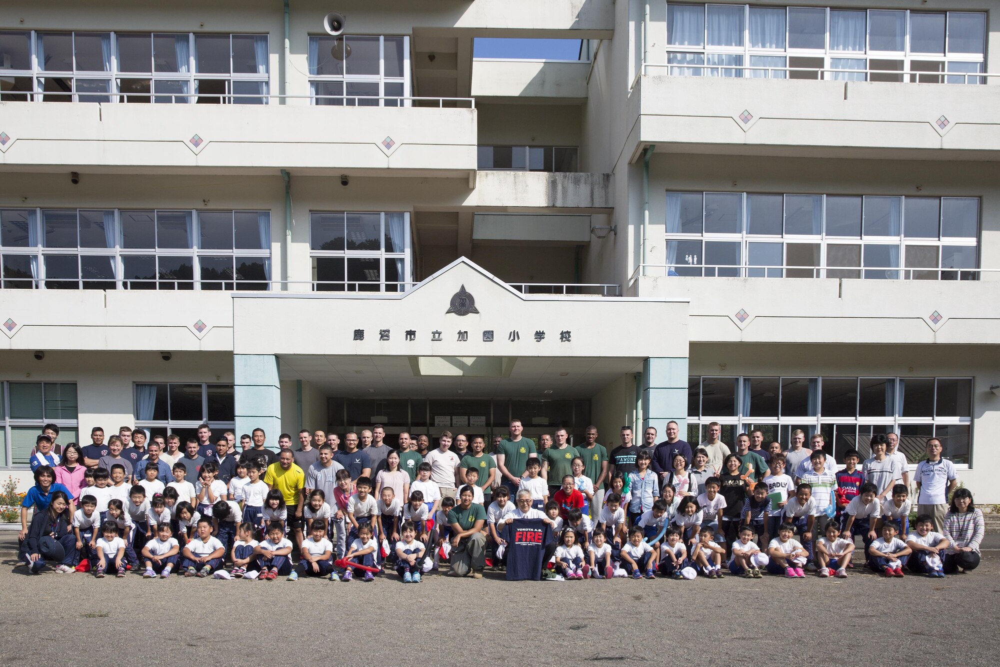 Sixty four students from the Kasono Elementary School and Airmen and civilians from the 374th Civil Engineer Squadron pose for a group photo after the appreciation ceremony at Kasono El-ementary School, Kanuma City, Tochigi Prefecture, Sept. 15, 2015. Sixty Airmen and civilians from the 374th CES volunteered to help at sites in the Kasono area in support of floods and landslides caused by the heavy rainfall associated with the post-tropical remnant of Tropical Storm Etau, which stalled over eastern Japan, dumping up to 17 inches of rain in 24 hours, from Sept. 10 to Sept. 11. (U.S. Air Force photo by Osakabe Yasuo/Released)