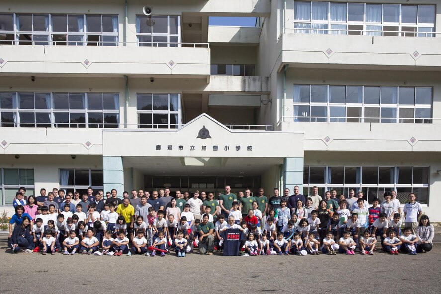 Sixty four students from the Kasono Elementary School and Airmen and civilians from the 374th Civil Engineer Squadron pose for a group photo after the appreciation ceremony at Kasono El-ementary School, Kanuma City, Tochigi Prefecture, Sept. 15, 2015. Sixty Airmen and civilians from the 374th CES volunteered to help at sites in the Kasono area in support of floods and landslides caused by the heavy rainfall associated with the post-tropical remnant of Tropical Storm Etau, which stalled over eastern Japan, dumping up to 17 inches of rain in 24 hours, from Sept. 10 to Sept. 11. (U.S. Air Force photo by Osakabe Yasuo/Released)