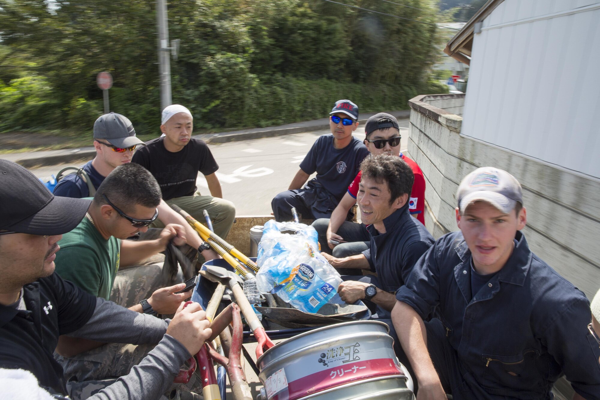Volunteers from the 374th Civil Engineer Squadron ride in the back of a pickup truck in support of landslide sites at Kanuma City, Tochigi Prefecture, Japan, Sept. 15, 2015. Sixty Airmen and civilians from the 374th CES volunteered to help at sites in the Kasono area in support of floods and landslides caused by the heavy rainfall associated with the post-tropical remnant of Tropical Storm Etau, which stalled over eastern Japan, dumping up to 17 inches of rain in 24 hours, from Sept. 10 to Sept. 11. (U.S. Air Force photo by Osakabe Yasuo/Released)