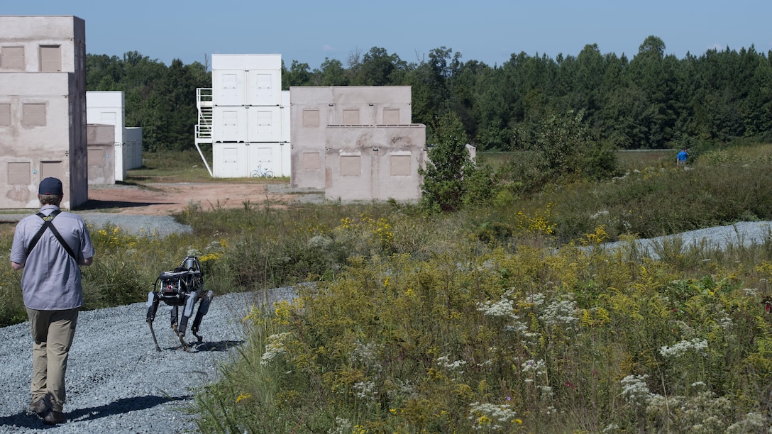 Ben Swilling, a roboticist with Boston Dynamics operates “Spot”, a quadruped prototype robot, during a demonstration at Marine Corps Base Quantico, Virginia., Sept. 16, 2015. Employees of the Defense Advanced Research Projects Agency trained Marines from the Marine Corps Warfighting Lab how to operate “Spot”.